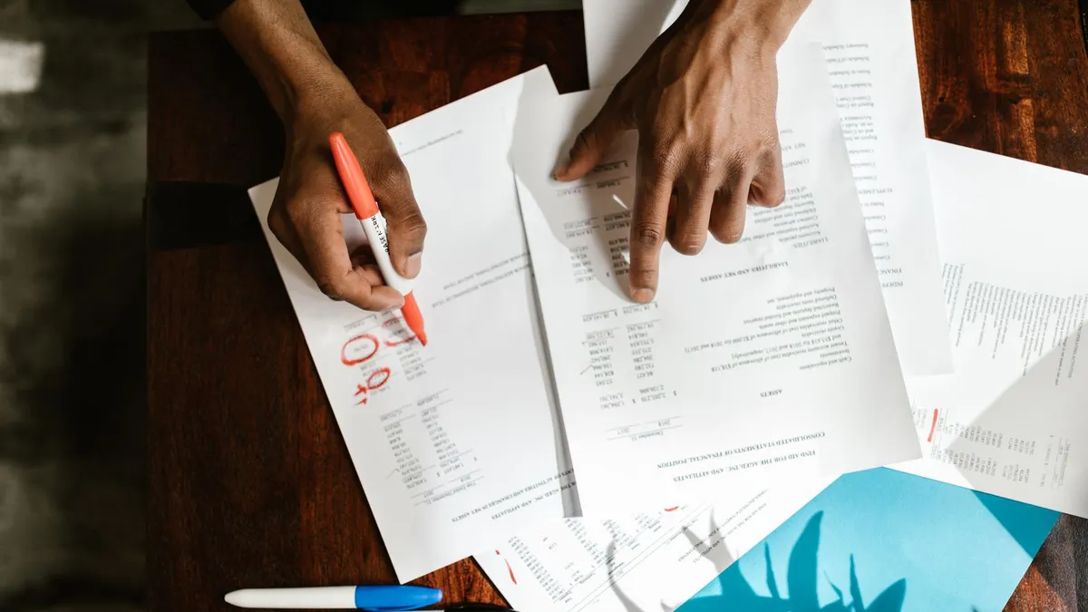 Person reviewing a Canada Revenue Agency notice with a calculator while comparing tax debt routes