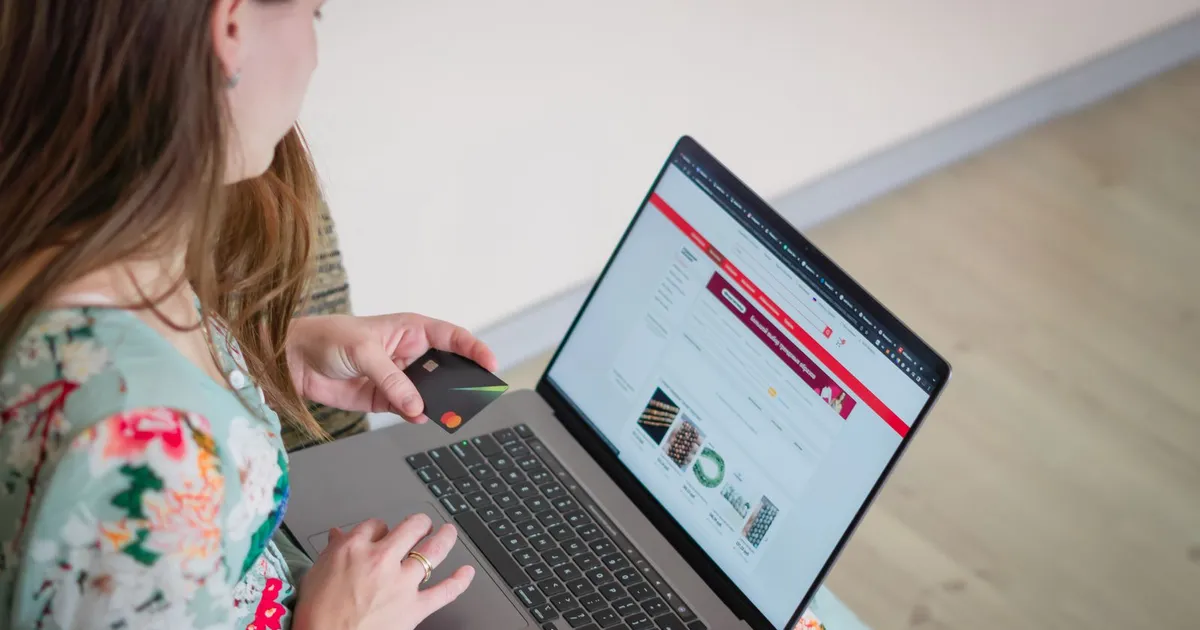 Credit card beside a laptop while comparing a credit card hardship program with a consumer proposal